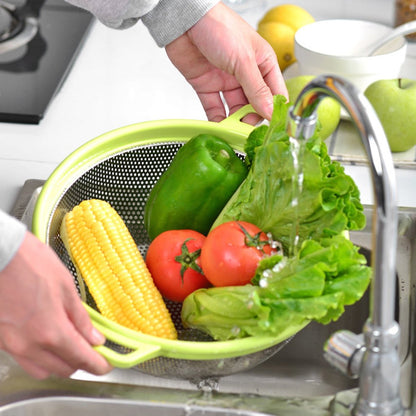 Large stainless steel colander with green handle