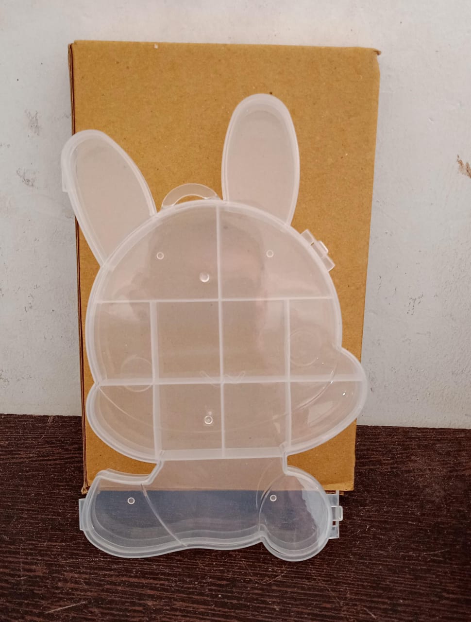 Clear plastic storage box with cartoon bear design.